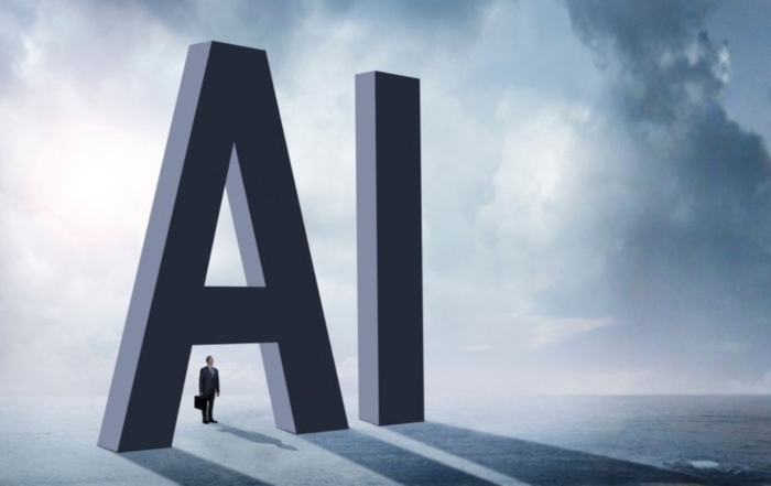 Small businessman standing beneath oversized AI letters, representing AI use for tax professionals